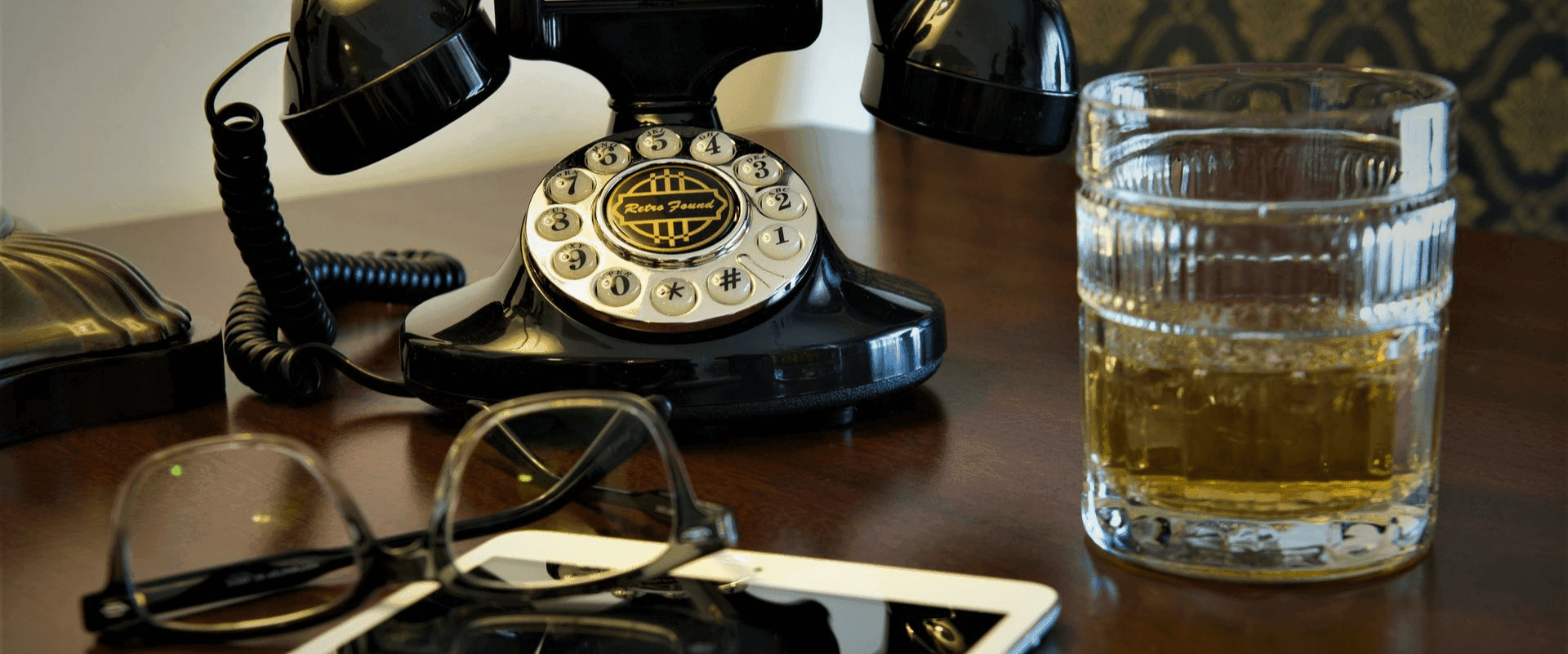 Vintage phone and glasses on the table at Vintage Hotel at Old Town Wichita