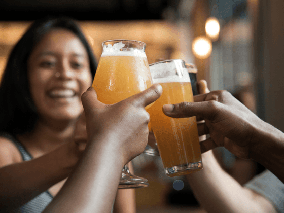 Two people clinking glasses of beer at the inn at Willow grove