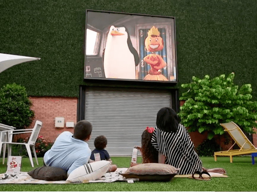 A family watching a movie in a courtyard at The Fredonia Hotel