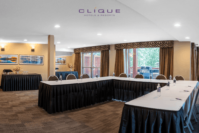 Meeting room at Falcon Crest Lodge is set up with a U-shaped conference table and chairs, ready for presentations