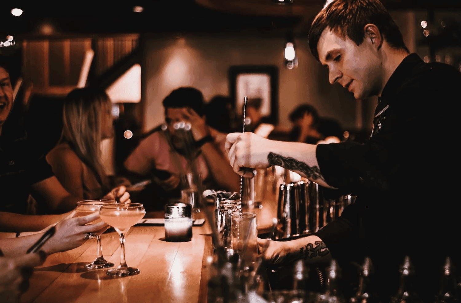 Bartender making drinks to the customers at Kinship Landing
