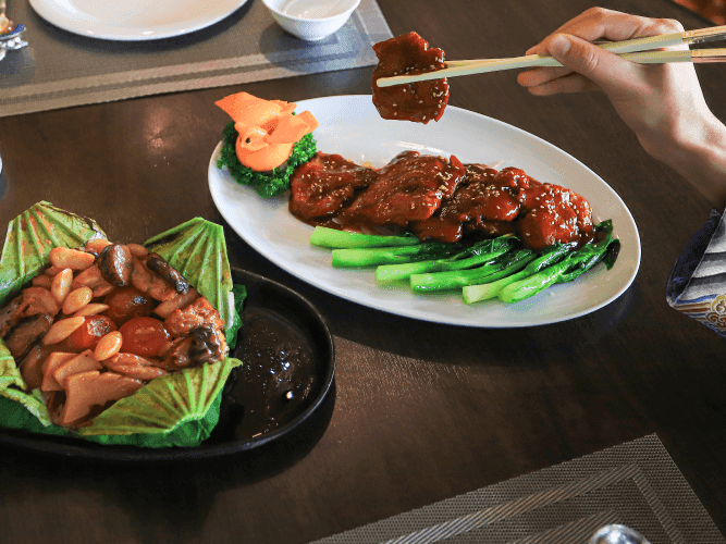 A person skillfully holding chopsticks to enjoy a delicious meal.
