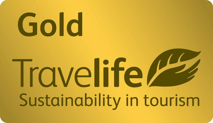 Travelife Gold sustainability award emblem for responsible green tourism at Worthing Court Apartment Hotel