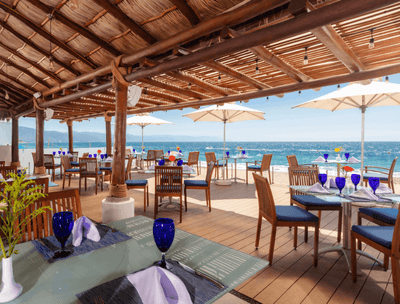 Sunset Restaurant with outdoor and indoor dining area overlooking sea at Buenaventura Grand Hotel and Spa