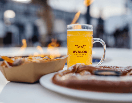 Glass of beer with pretzel and meat served at our NJ shore hotel