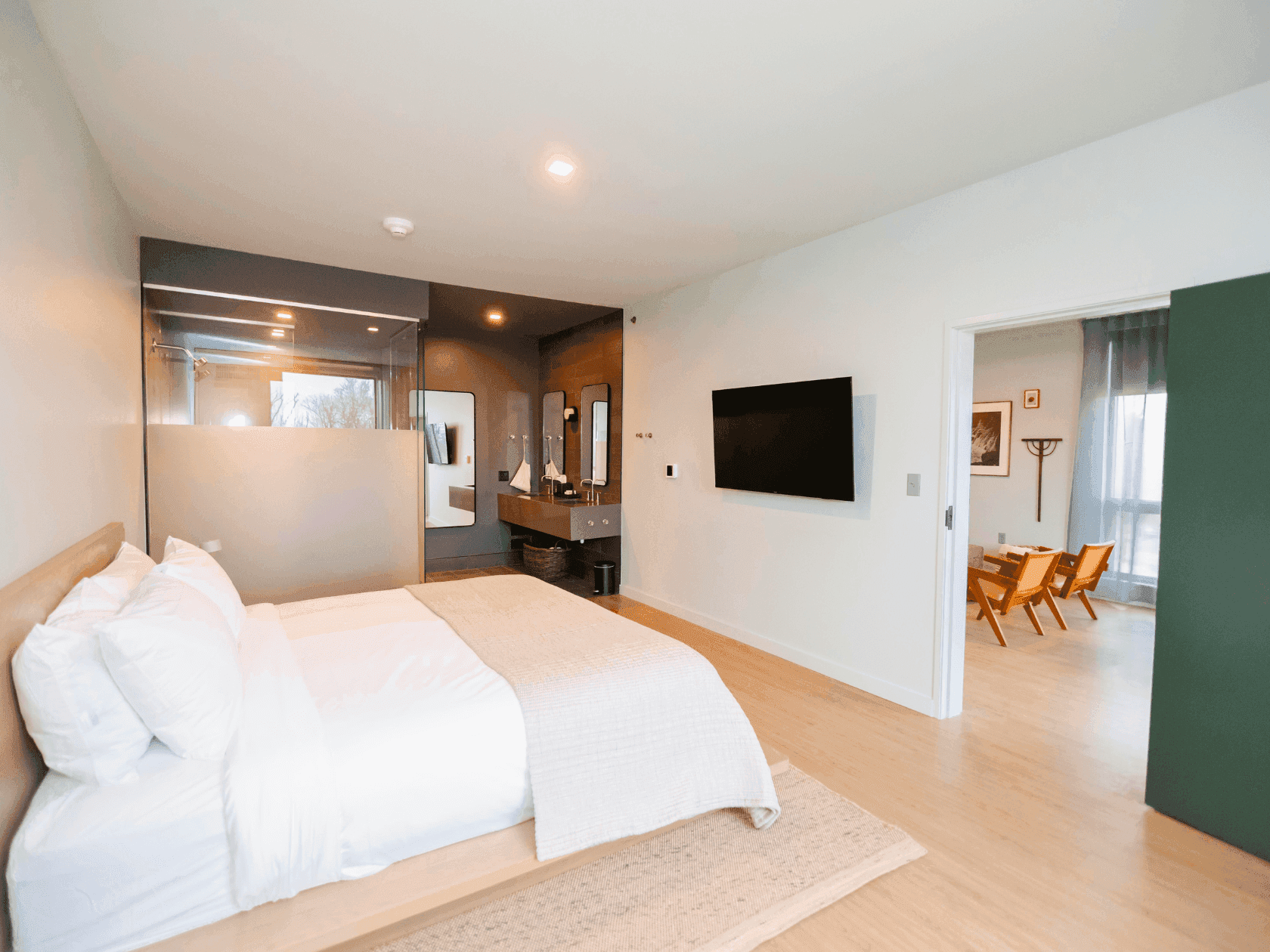 The Signature Suite at Stonebreaker showing off the bedroom with a roll-in skin and roll-in shower