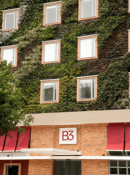 Exterior of Hotel B3 Virrey with green living walls & framed windows near Unika Hotels, a featured hotel in Bogota, Colombia