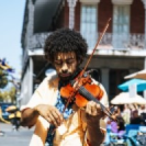 A man playing violin in the streets near La Galerie Hotel