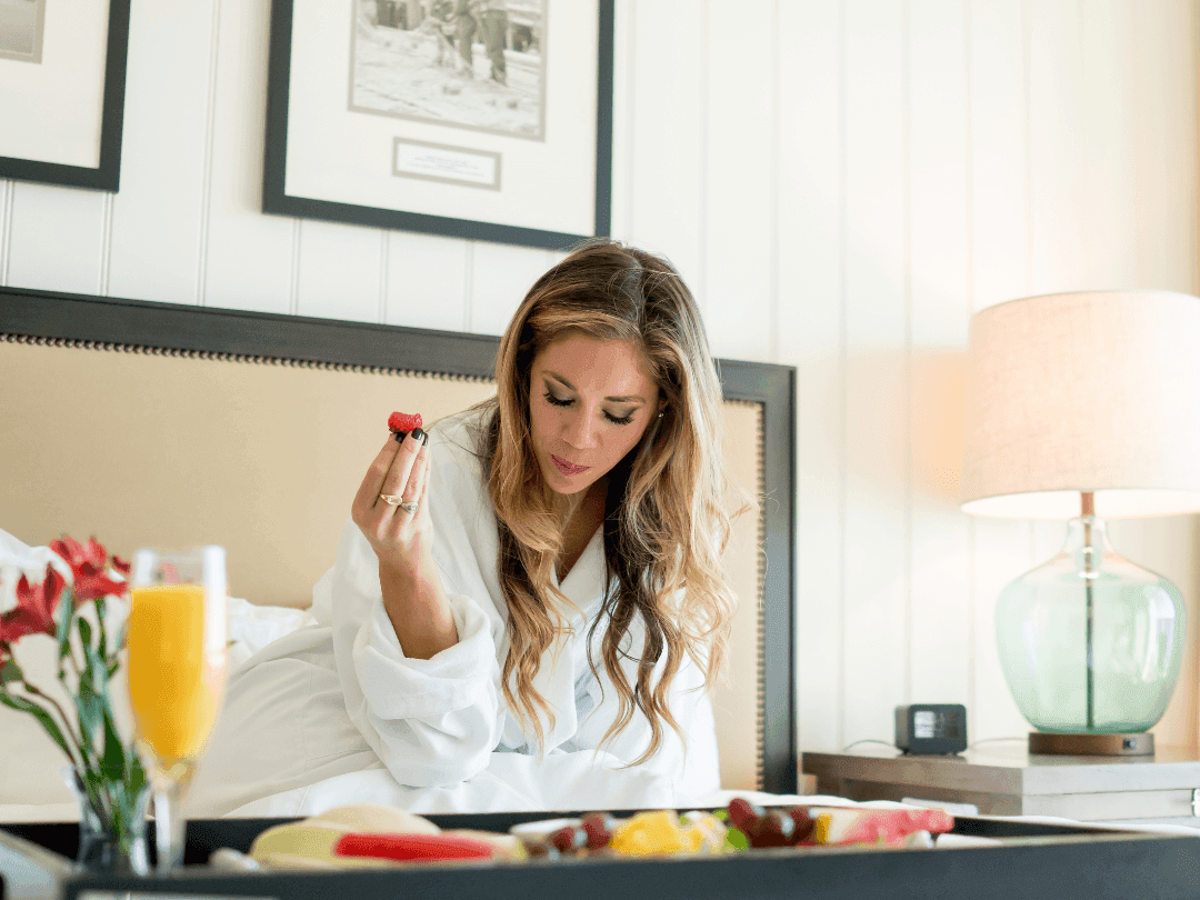 Lady having breakfast on the bed at Beauport Hotel Gloucester