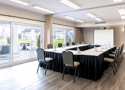 U-shaped conference meeting room setup with projector screen at Charlottetown Event Grounds in Rodd Crowbush Golf & Resort