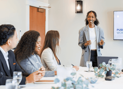 Business presenter speaking to colleagues seated around a conference table at Rodd Crowbush Golf & Beach Resort