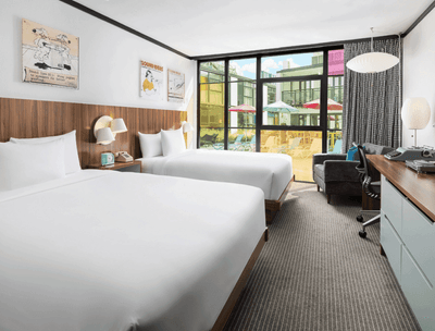 Work desk & lounger facing the beds in Pool View Queen at The Verb Hotel