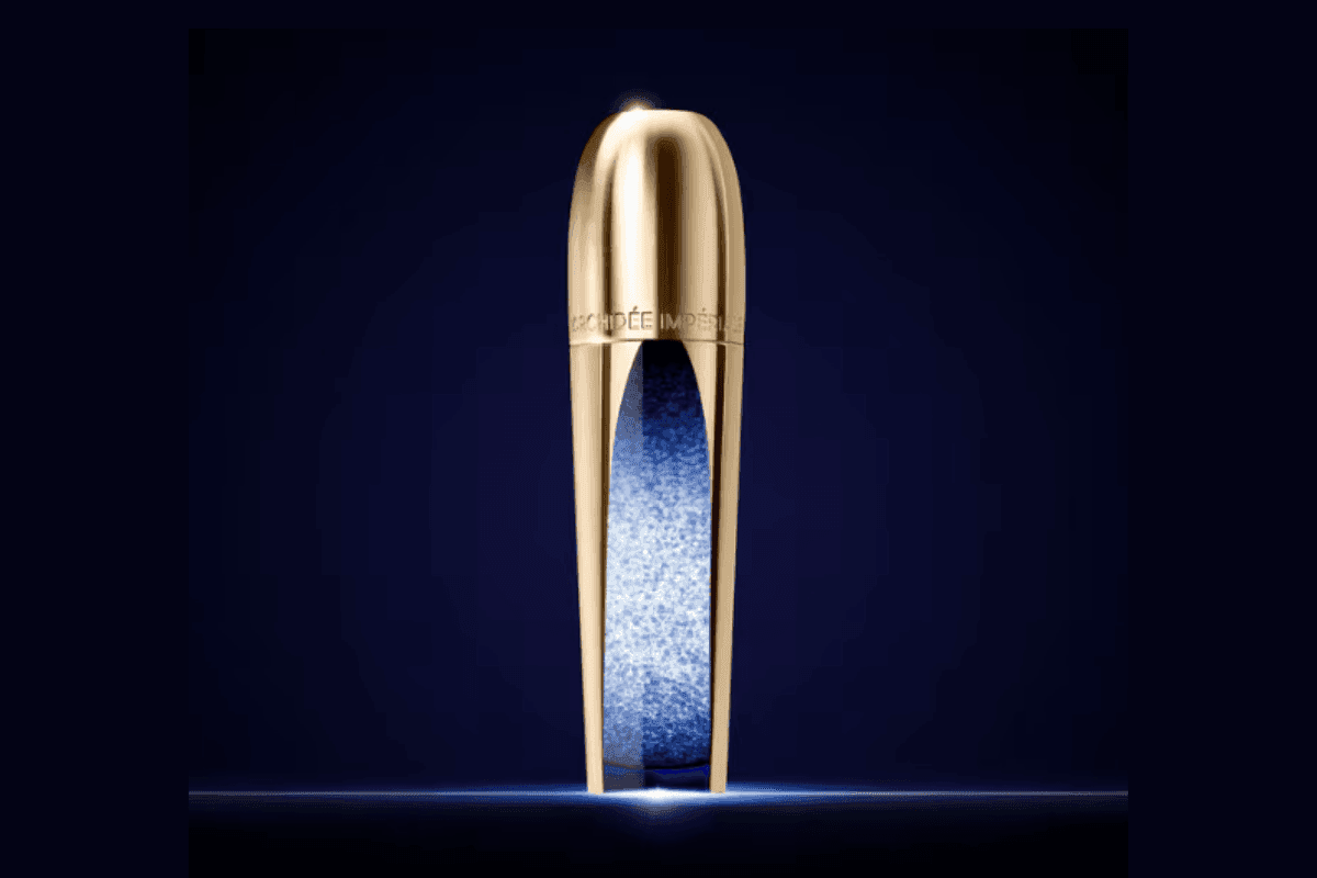 Guerlain Orchidée Impériale gold skincare bottle with blue center under soft light on a dark backdrop at Hotel X Toronto