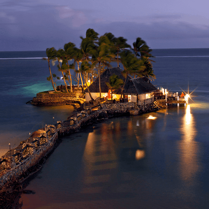 Aerial view of a beautifully lit island surrounded by ocean near Warwick Le Crystal - Montréal