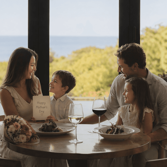 Family celebrating Mother's Day with a meal and flowers.