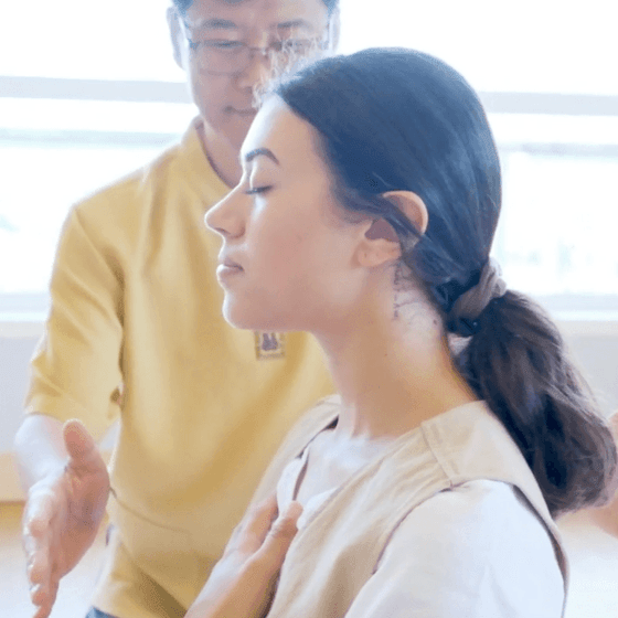 Man helping a woman in chakra meditating at Honor’s Haven Retreat