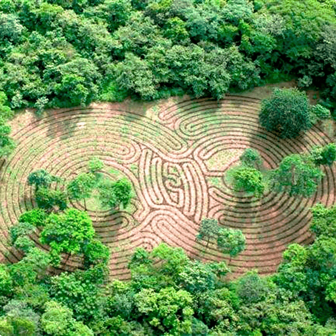 Aerial shot of the peaceful meditation labyrinth nestled in the lush green jungle at Cala Luna Boutique Hotel