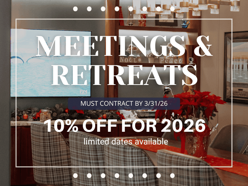 photo of long family style table, comfy chairs and television