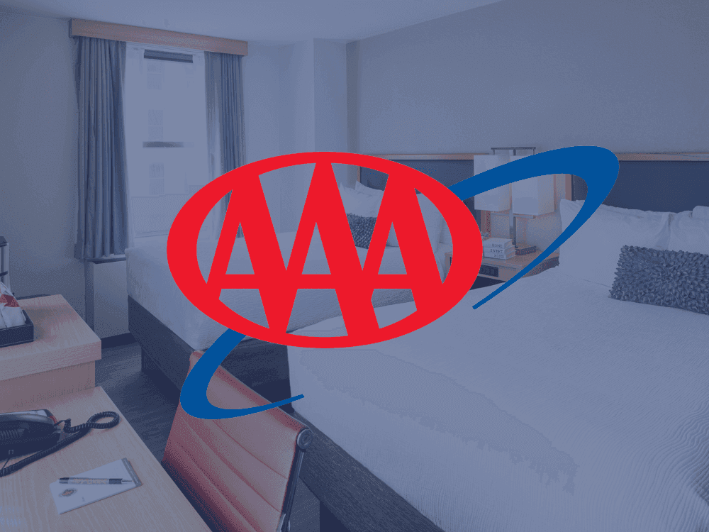 AAA logo over a picture of a double bed room at Hotel Saint Clair