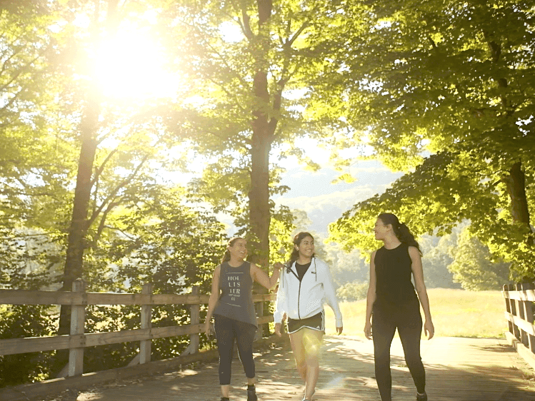 Ladies walking through the bridge near Honor’s Haven Retreat