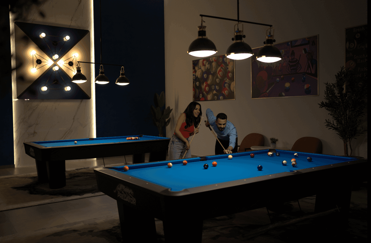Couple enjoying billiards game together in the stylish lounge in Level Up - Indoor Gaming Hub at DAMAC Maison Aykon City
