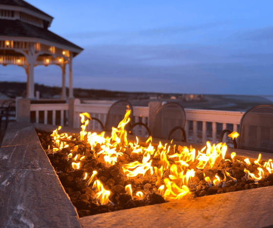 Outdoor fire pit overlooking the coast at Anchorage By The Sea
