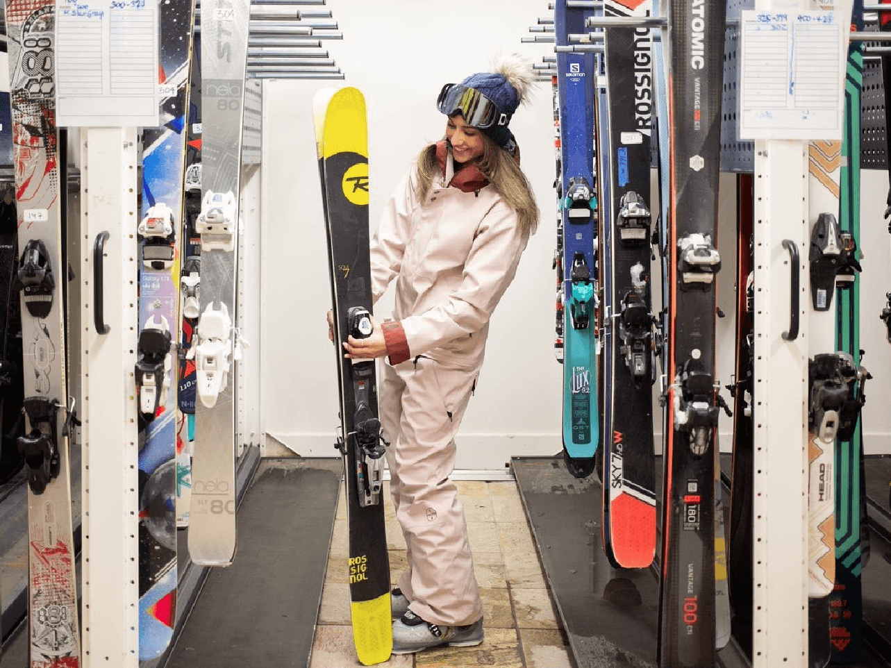 Women holding a ski in Ski and Bike Storage at Blackcomb Springs Suites