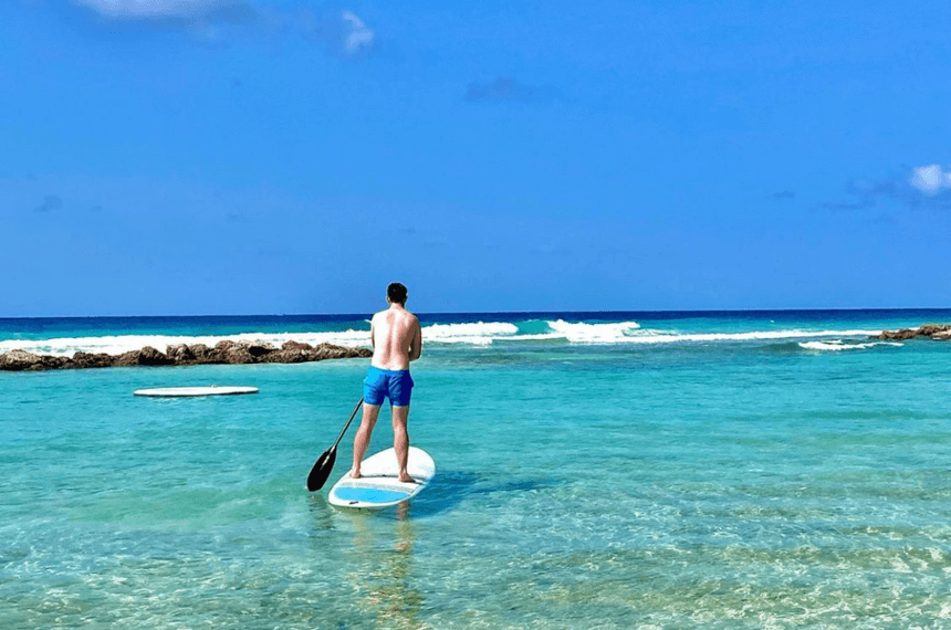 A man on a paddle boarding in the sea near Sugar Bay Barbados