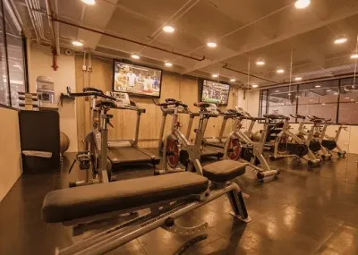 Gym with treadmills, exercise bikes, and a weight bench at Unika Hotels, fine for the best area to stay in Bogota