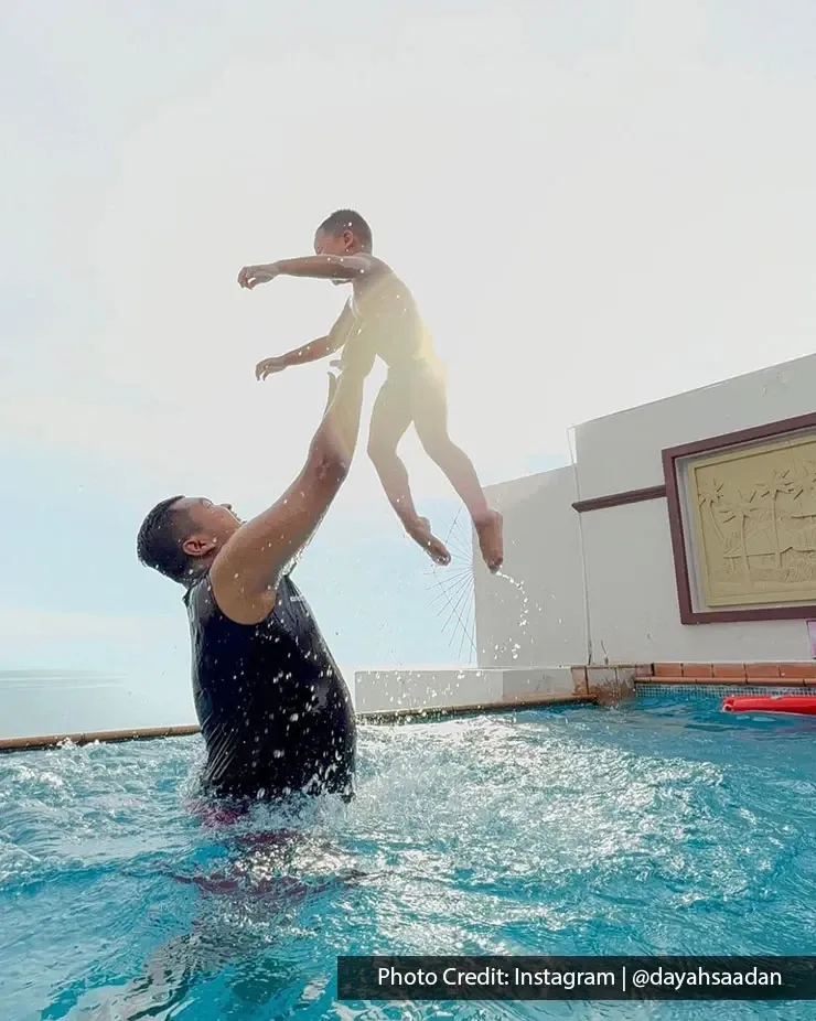 Parent lifting child in private pool at Grand Lexis Port Dickson.
