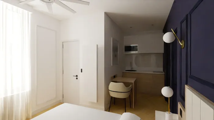 Chambre moderne avec cuisine et bureau intégrés chez Les Sources Callou.