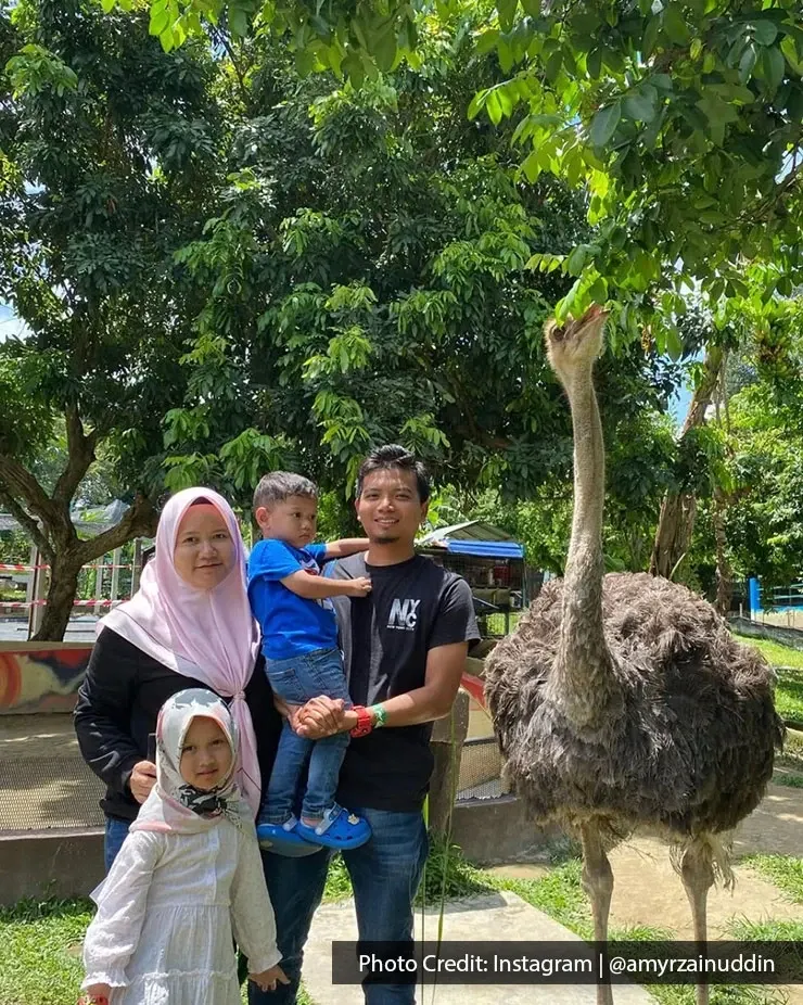 Family posing with an ostrich at PD Ostrich & Pets Show Farm.