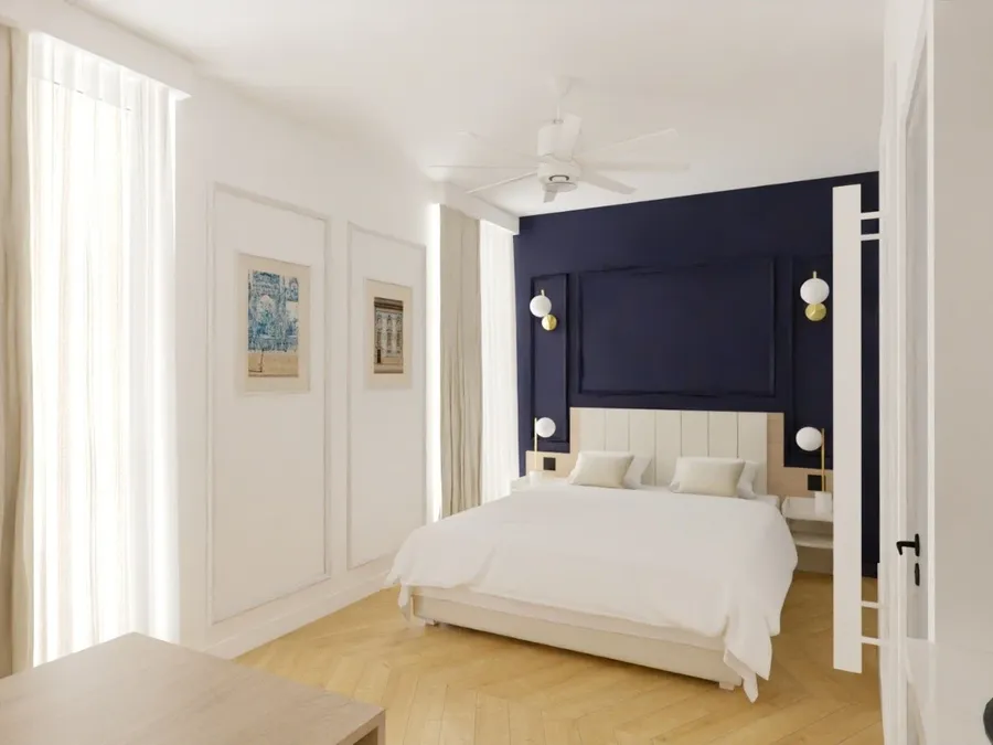 Chambre Appart Deluxe avec lit double et mur bleu marine chez Les Sources Callou à Vichy.