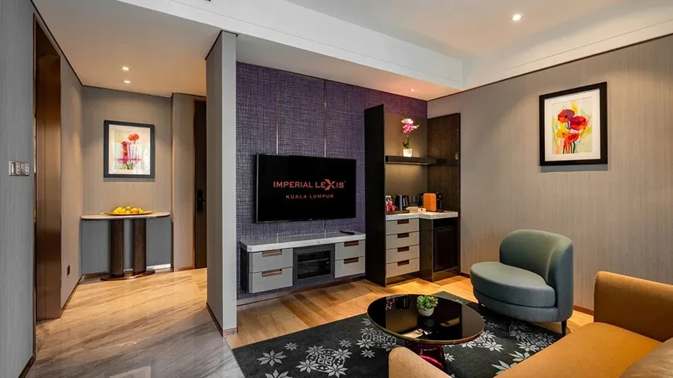 Sophisticated living area in a high-floor luxury hotel suite at Imperial Lexis KL with modern decor.