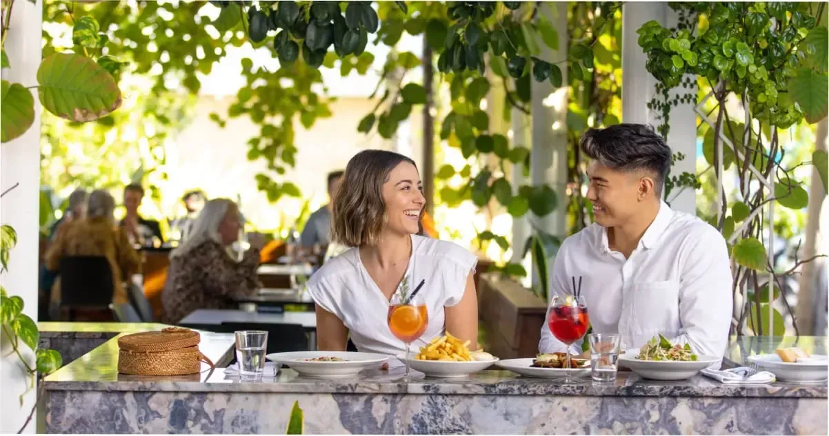 A couple enjoying a meal and drinks at a restaurant on James Street, Brisbane