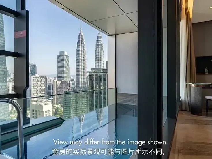 Luxury hotel room at Imperial Lexis KL featuring a private balcony pool with a direct Petronas Twin Towers view.