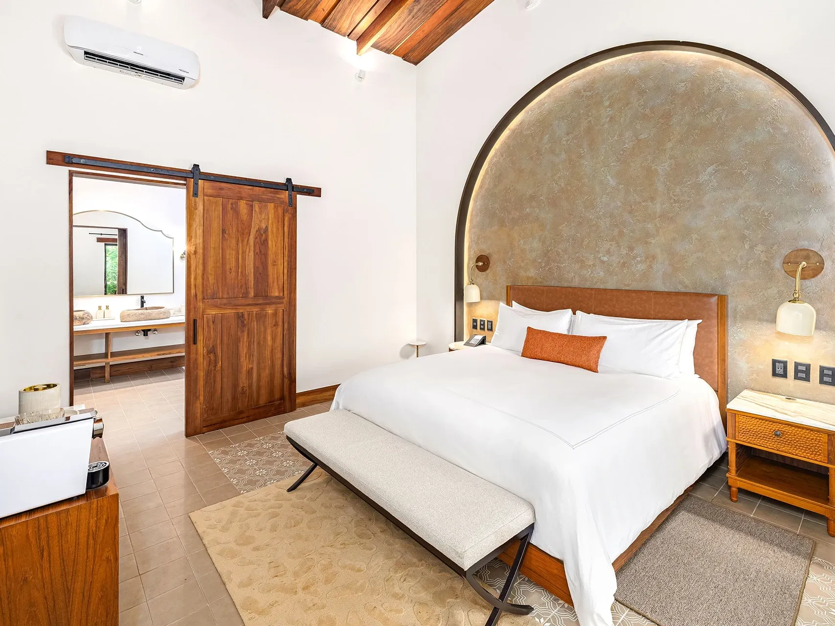 Suite Junior con una pared decorativa detrás de la cama y un asiento junto a la ventana en Santa Lucía Jungle Hacienda, Villa Lapas Jungle Village