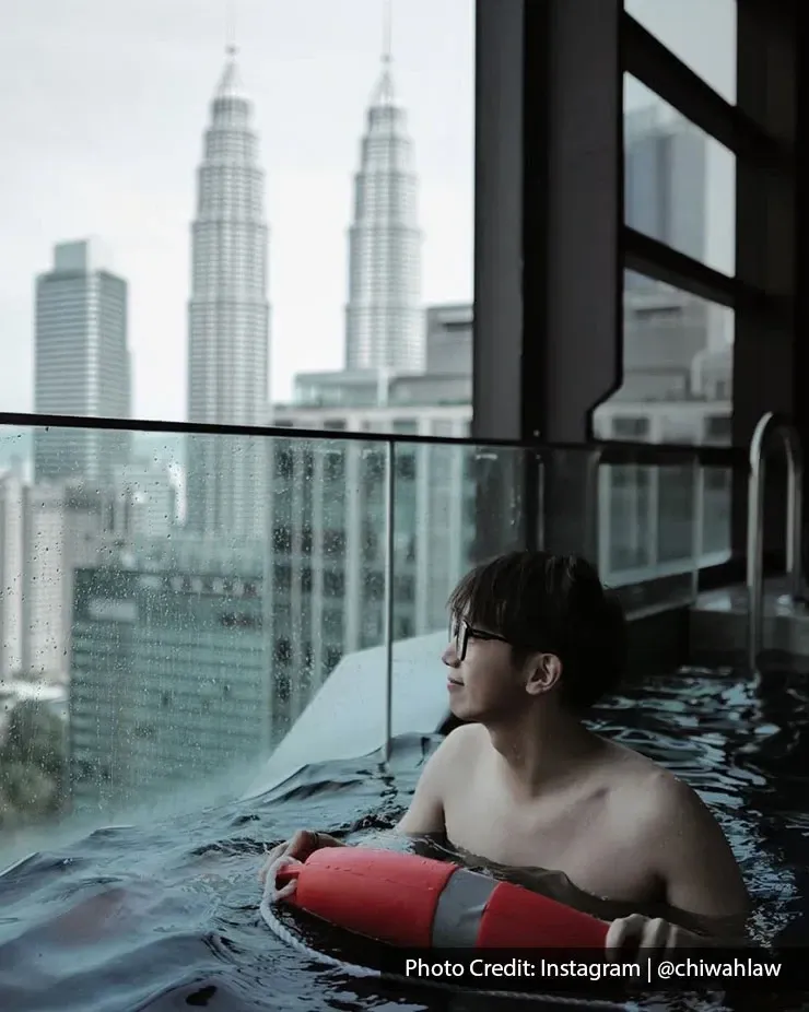 Guest relaxing in a private pool with Petronas Twin Towers views
