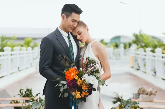  A bride and groom embracing each other while dressed in elegant wedding outfits at Lexis Hibiscus Port Dickson