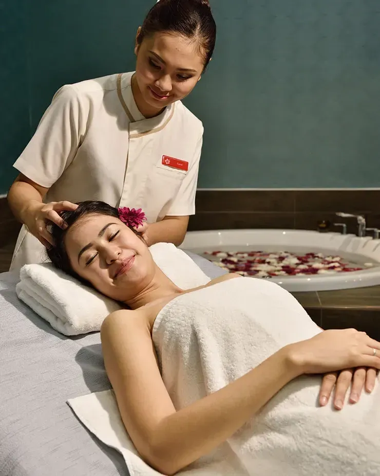 A lady relaxing with a massage from trained staff during her digital detox vacation - Lexis MY