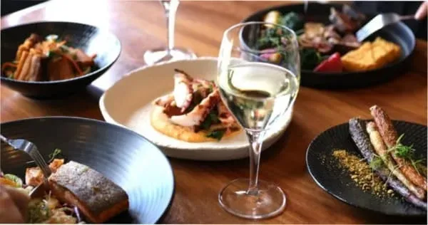 A table of food and wine at the Hotel Grand Chancellor on-site restaurant