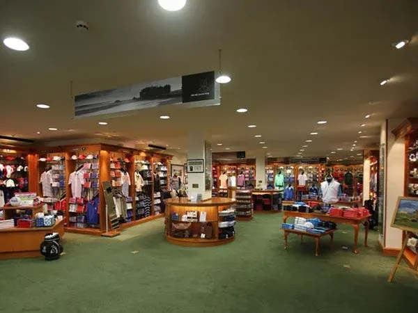 Spacious store featuring neatly arranged clothing displays, central checkout, and well-lit surroundings near Seaton House