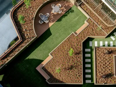 Aerial view of Caulfield Place featuring outdoor seating, greenery, and modern architecture.