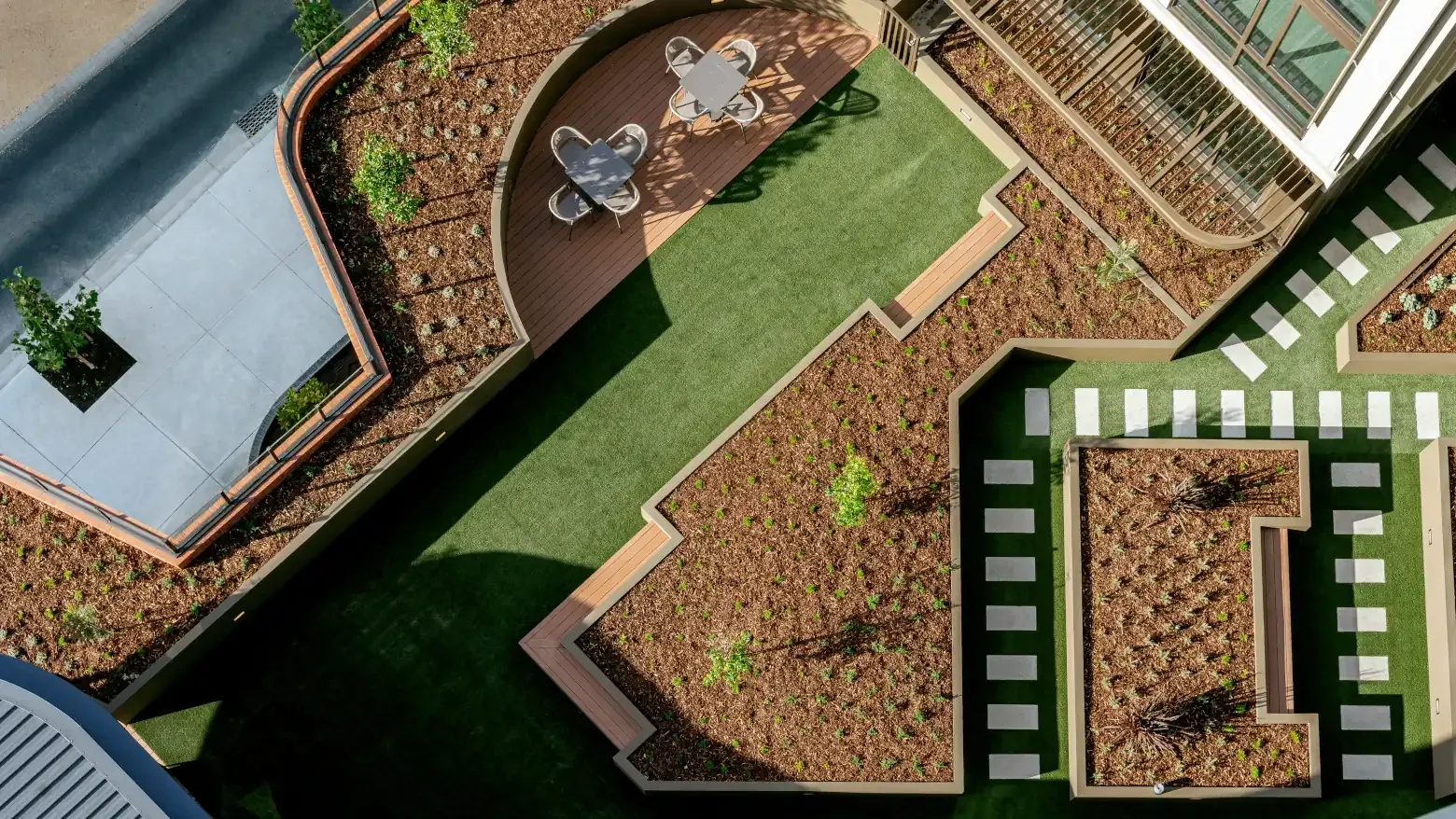 Aerial view of Caulfield Place featuring outdoor seating, greenery, and modern architecture.