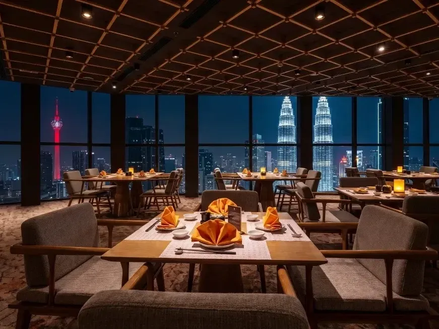 UMI Japanese Restaurant dining area with city skyline views featuring illuminated KL Tower and Petronas Twin Towers at Imperial Lexis Kuala Lumpur