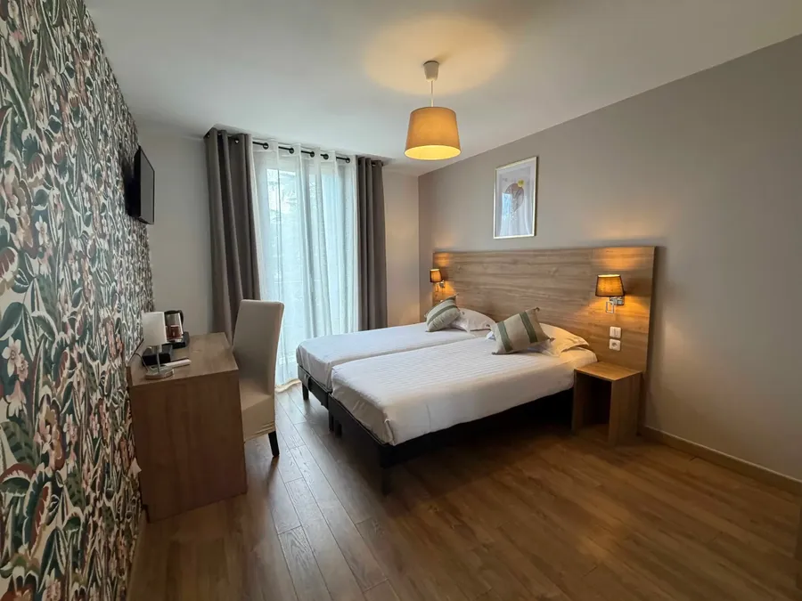 Chambre confort twin avec deux lits et décoration élégante au Grand Hôtel Molière à Pézenas.
