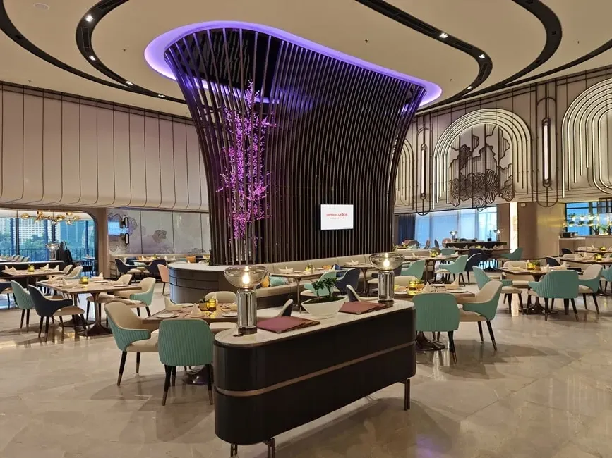 The grand dining hall of Roselle Coffee House at Imperial Lexis KL with a striking purple light installation.