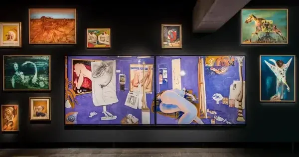 Gallery wall displaying eclectic paintings, including large blue artwork and surreal pieces