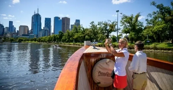 People take photos on a Yarra River cruise