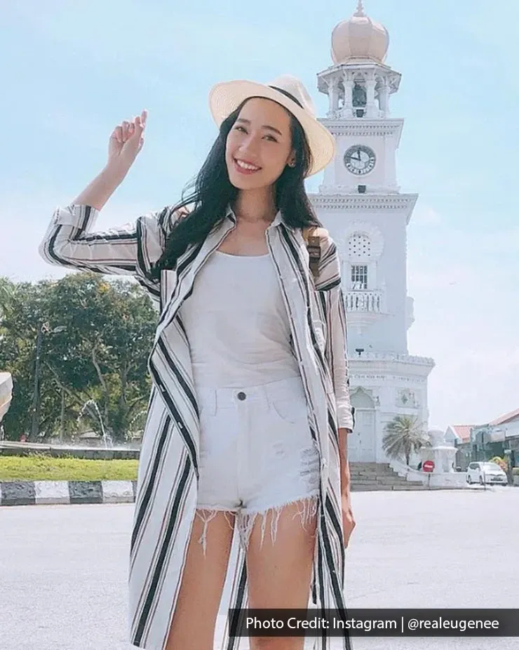 Tourist standing near Queen Victoria Memorial Clock Tower landmark in George Town Penang.